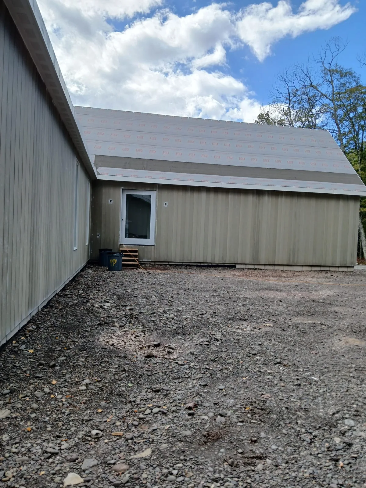 New home exterior with fresh siding and roof underlayment